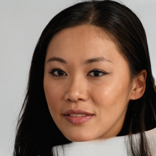 Joyful asian young-adult female with long  brown hair and brown eyes