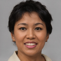 Joyful asian young-adult female with short  brown hair and brown eyes