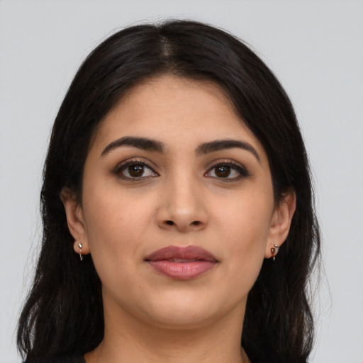 Joyful latino young-adult female with long  brown hair and brown eyes