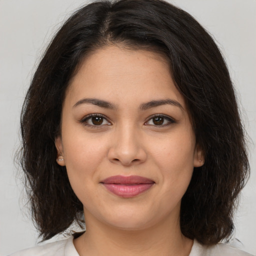 Joyful white young-adult female with medium  brown hair and brown eyes