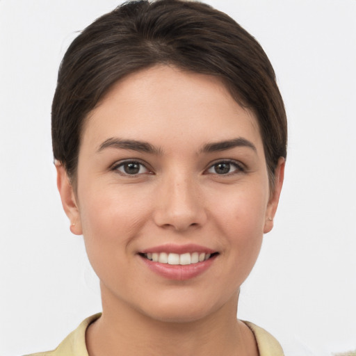 Joyful white young-adult female with short  brown hair and brown eyes