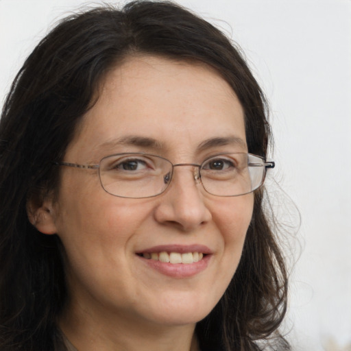 Joyful white adult female with long  brown hair and brown eyes