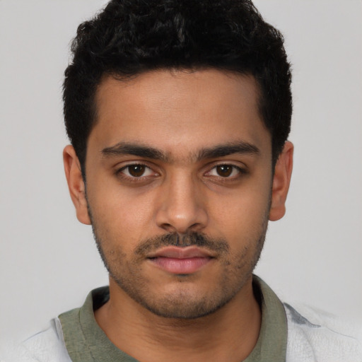 Neutral latino young-adult male with short  black hair and brown eyes