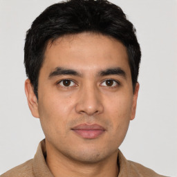 Joyful white young-adult male with short  black hair and brown eyes