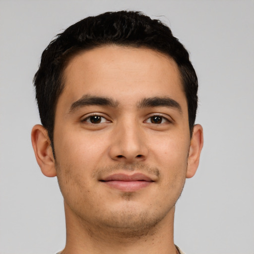 Joyful latino young-adult male with short  black hair and brown eyes