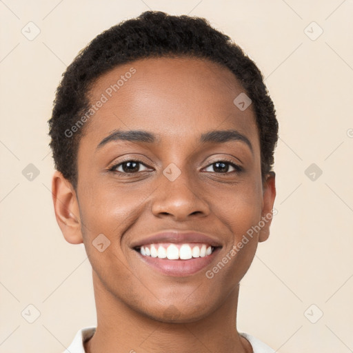 Joyful black young-adult female with short  brown hair and brown eyes