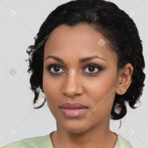 Joyful black young-adult female with medium  black hair and brown eyes