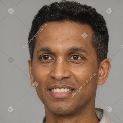 Joyful latino adult male with short  black hair and brown eyes