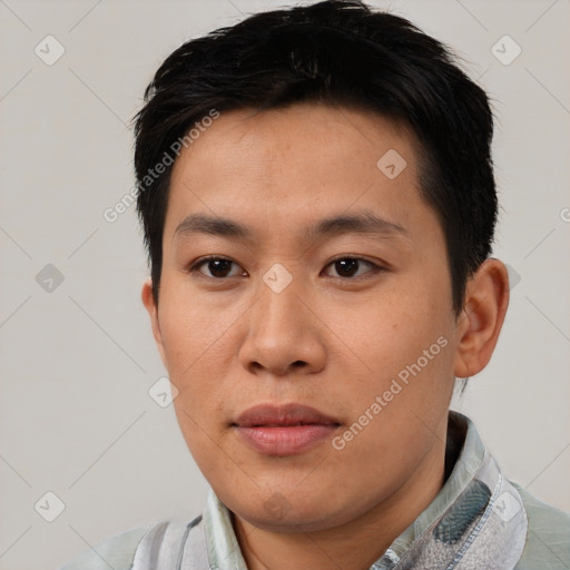 Joyful asian young-adult male with short  black hair and brown eyes