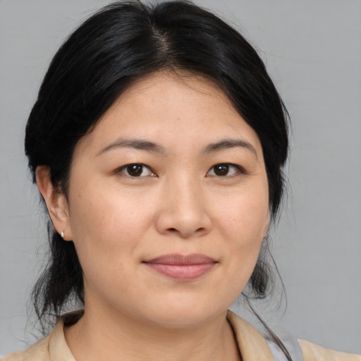 Joyful asian young-adult female with medium  brown hair and brown eyes