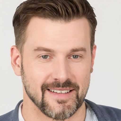 Joyful white adult male with short  brown hair and brown eyes