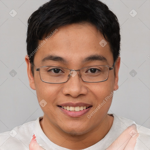 Joyful asian young-adult male with short  brown hair and brown eyes