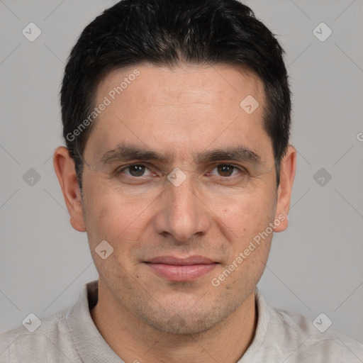 Joyful white adult male with short  black hair and brown eyes