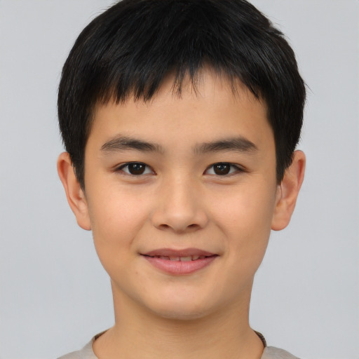 Joyful asian child male with short  brown hair and brown eyes