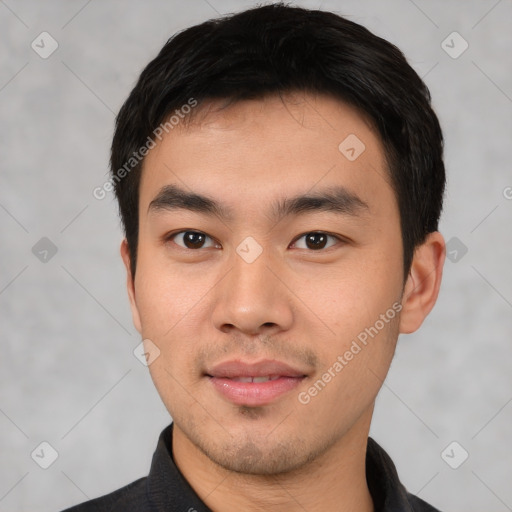 Joyful asian young-adult male with short  black hair and brown eyes