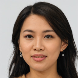 Joyful asian young-adult female with long  brown hair and brown eyes