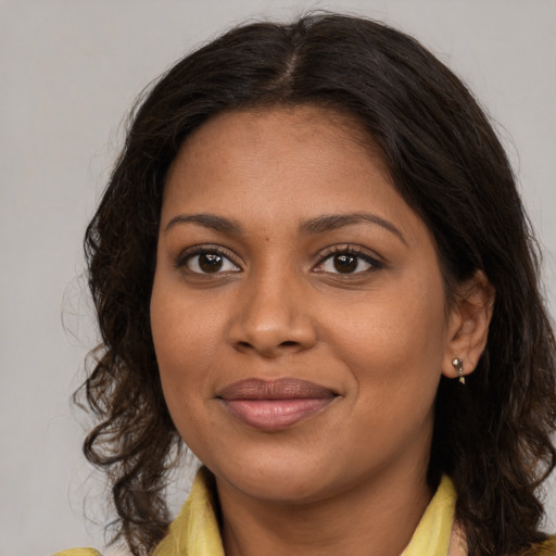 Joyful black young-adult female with medium  brown hair and brown eyes