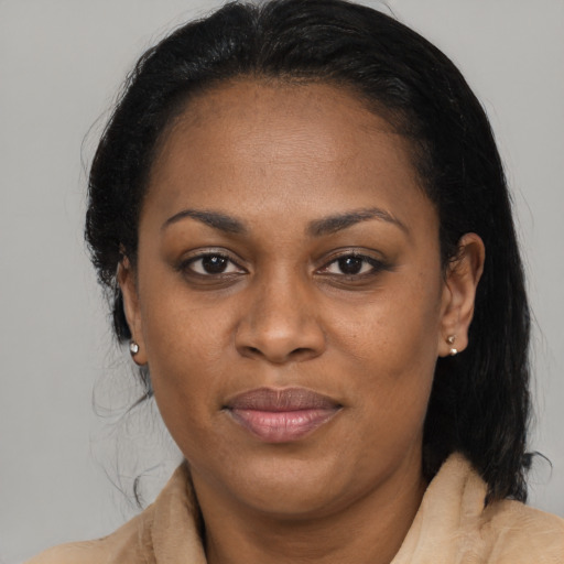 Joyful black young-adult female with medium  black hair and brown eyes