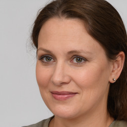 Joyful white adult female with medium  brown hair and grey eyes