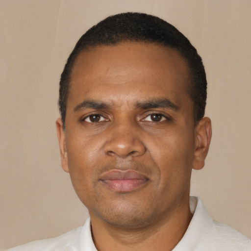 Joyful black adult male with short  black hair and brown eyes