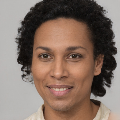 Joyful black adult female with short  brown hair and brown eyes
