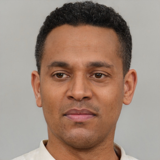 Neutral latino adult male with short  black hair and brown eyes