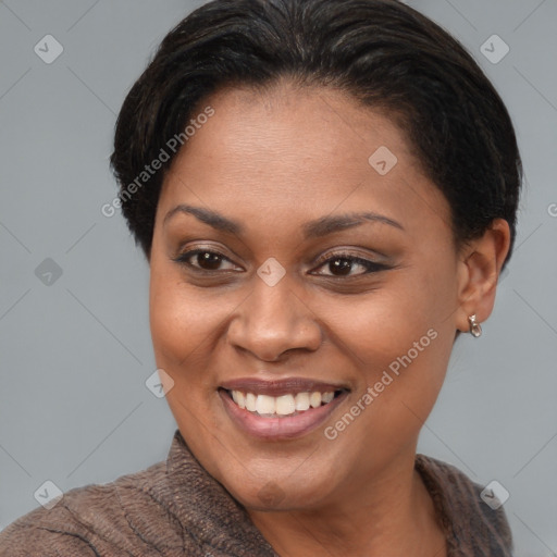 Joyful black young-adult female with short  brown hair and brown eyes