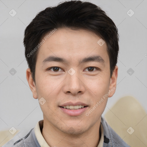 Joyful asian young-adult male with short  brown hair and brown eyes