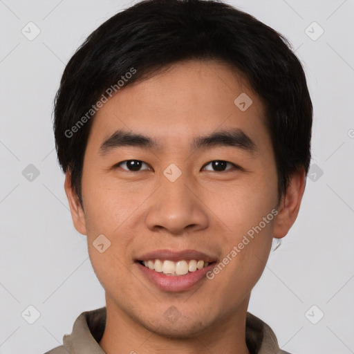 Joyful asian young-adult male with short  brown hair and brown eyes