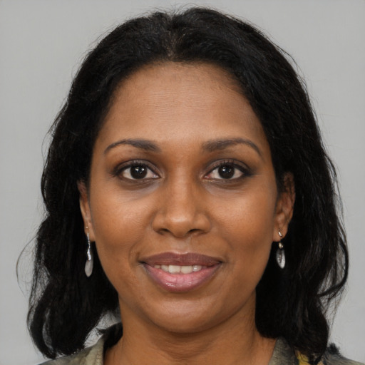 Joyful black adult female with medium  brown hair and brown eyes