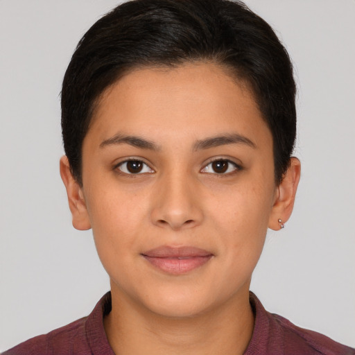 Joyful latino young-adult female with short  brown hair and brown eyes