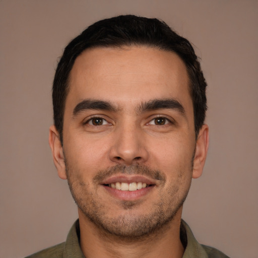 Joyful white young-adult male with short  brown hair and brown eyes