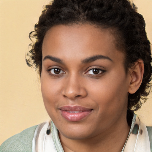 Joyful black young-adult female with medium  brown hair and brown eyes