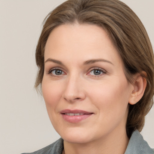 Joyful white adult female with medium  brown hair and brown eyes