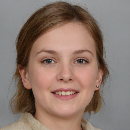 Joyful white young-adult female with medium  brown hair and blue eyes