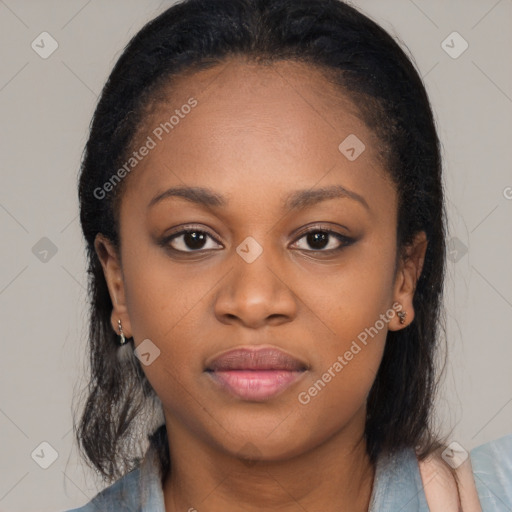 Joyful black young-adult female with long  brown hair and brown eyes