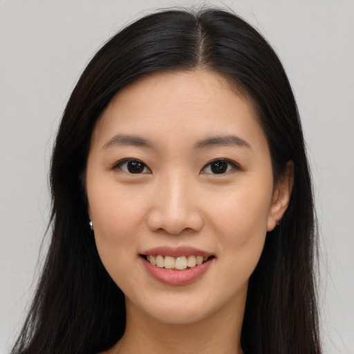 Joyful asian young-adult female with long  brown hair and brown eyes