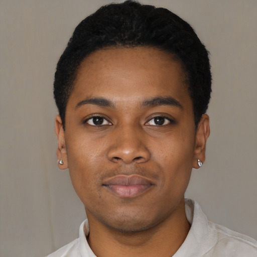 Joyful black young-adult male with short  black hair and brown eyes