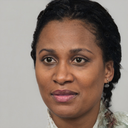 Joyful black adult female with short  brown hair and brown eyes