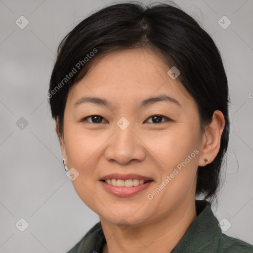 Joyful asian adult female with medium  brown hair and brown eyes