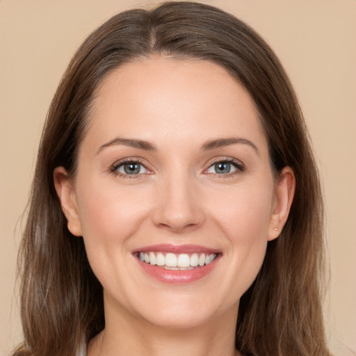 Joyful white young-adult female with long  brown hair and brown eyes