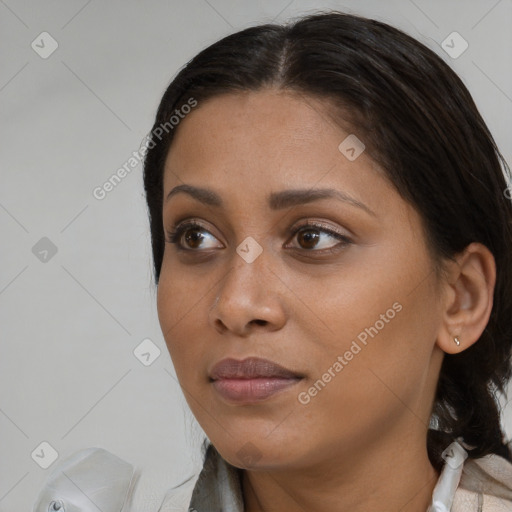 Joyful black young-adult female with medium  brown hair and brown eyes