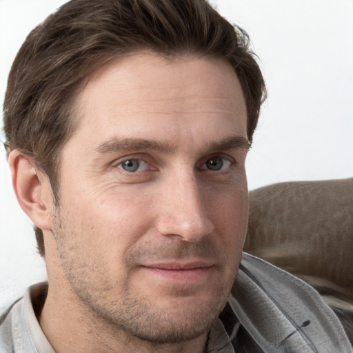 Joyful white adult male with short  brown hair and grey eyes