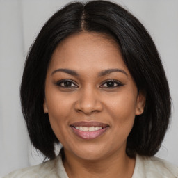 Joyful black young-adult female with medium  brown hair and brown eyes