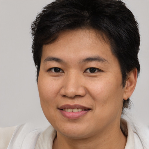 Joyful asian young-adult female with short  brown hair and brown eyes