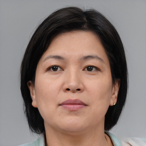 Neutral asian adult female with medium  brown hair and brown eyes
