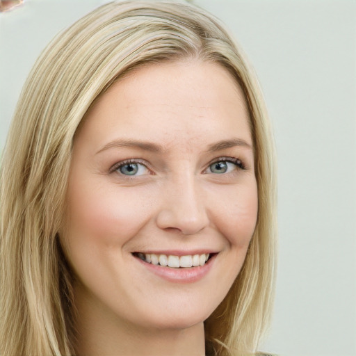 Joyful white young-adult female with long  brown hair and blue eyes