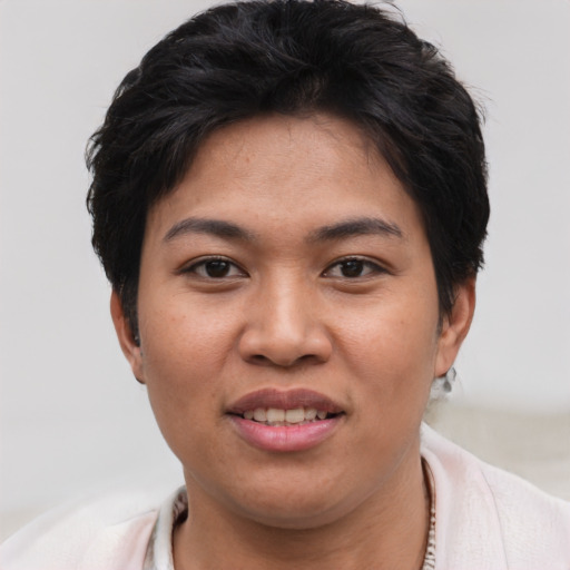 Joyful asian young-adult female with short  brown hair and brown eyes