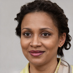 Joyful latino adult female with short  brown hair and brown eyes