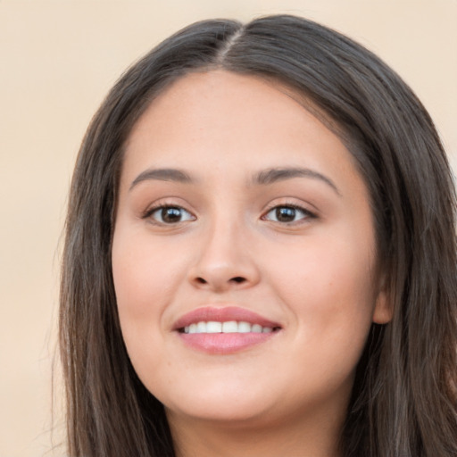 Joyful white young-adult female with long  brown hair and brown eyes